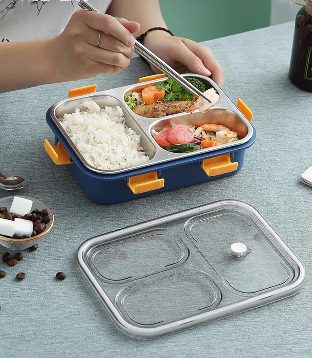 A person enjoying lunch from a lunch box, highlighting a casual dining experience in a serene setting.
